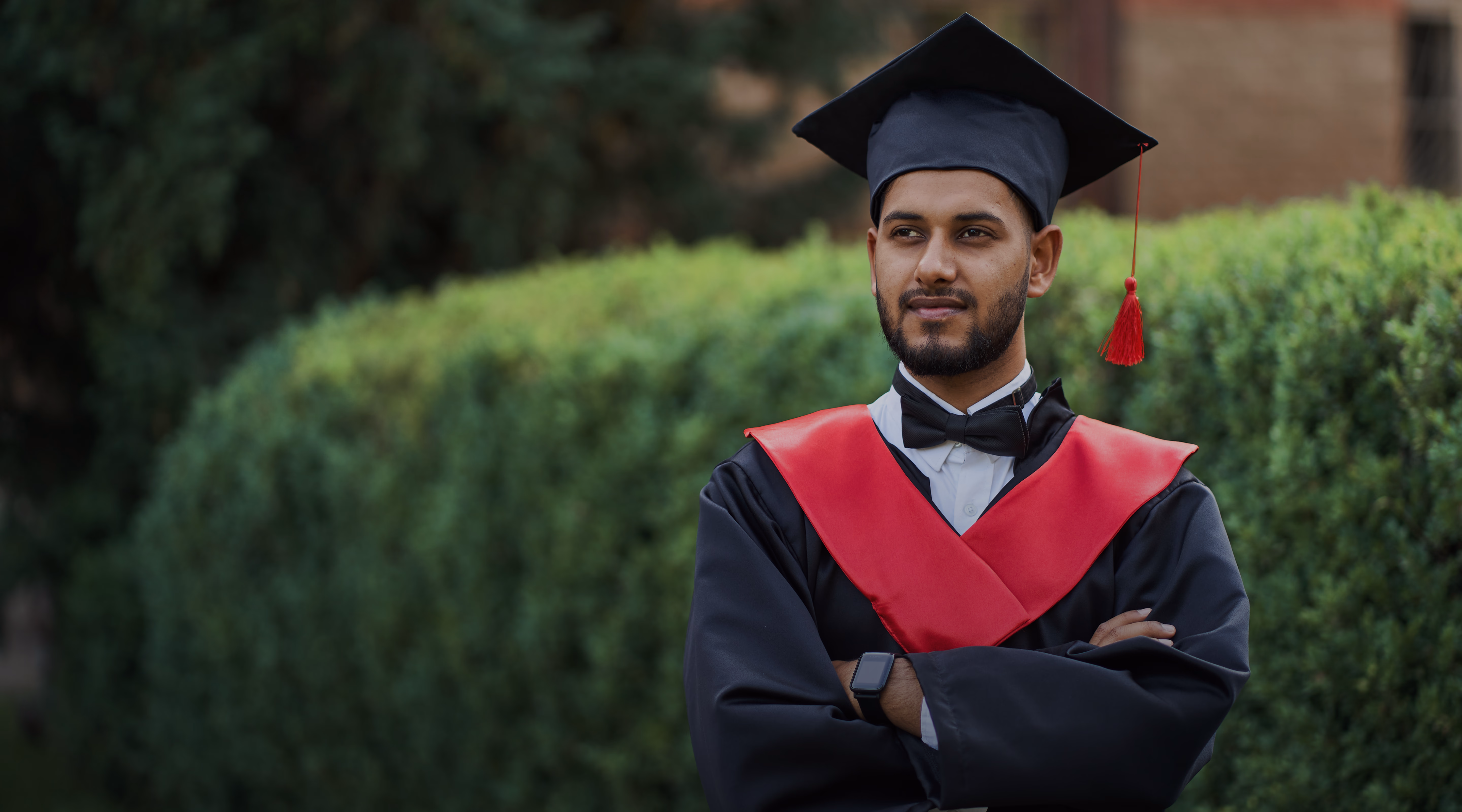 Career Axis graduate in cap and gown